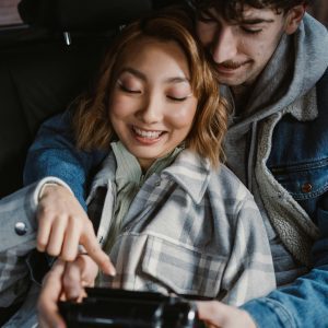 A Loving Couple Enjoys A Happy Moment Inside A Car, Capturing Memories Together.