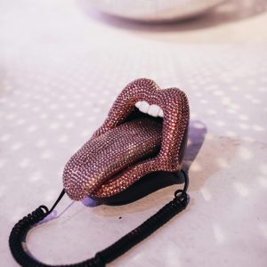 Stylish Retro Lip Shaped Telephone On Dancefloor With Disco Ball Reflections.