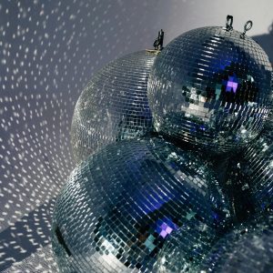 Cluster Of Disco Balls Casting Shimmering Reflections, Embodying Retro And Festive Vibes.