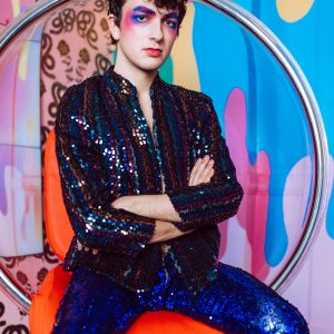 Colorful Portrait Of A Man With Styled Makeup In Sequin Outfit, Indoors.