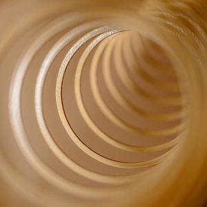 Close Up Abstract Image Of Golden Spirals Creating A Tunnel Effect.