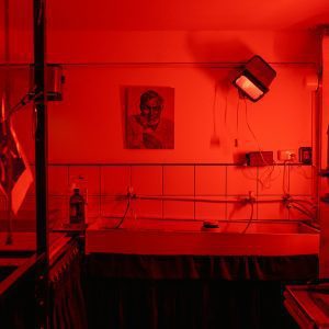 A Nostalgic Look At A Red Lit Film Photography Darkroom, Evoking Vintage Charm And Analog Processes.