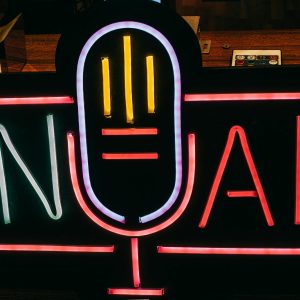 Bright Neon 'On Air' Sign Glowing In A Dark Studio, Perfect For Broadcasting Themes.
