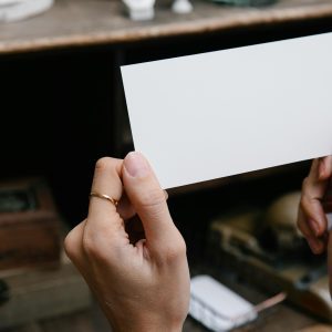 A Blank Rectangular Card Is Held By Hands, Offering Copy Space For Text Or Design.
