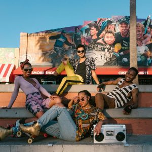 Group Of Diverse Friends Enjoying A Sunny Day With Roller Skates And A Boombox.