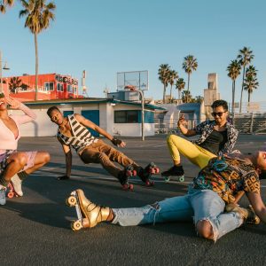 Diverse Group Of Stylish Young Adults Enjoying Roller Skating In A Sunny Park.