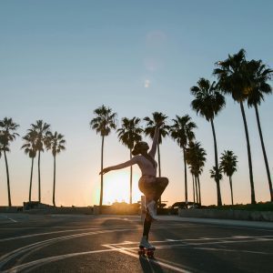 Dynamic Silhouette Of A Roller Skater During Sunset At Venice Beach, Featuring Palm Trees And An Iconic Californian Vibe.