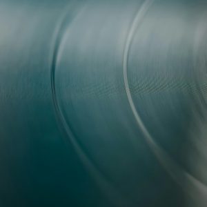 Blurred Close Up Of A Vinyl Record's Grooves, Creating A Soothing Abstract Pattern.