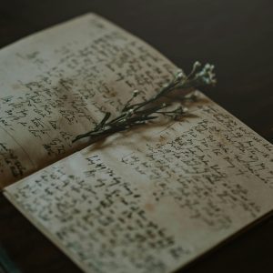 A Vintage Notebook With Handwritten Notes And Delicate Flowers, Evoking Nostalgia And Warmth.