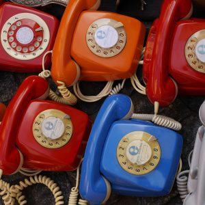 A Collection Of Colorful Vintage Rotary Telephones Evokes Nostalgic Charm And Retro Style.
