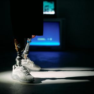 Studio Shot Showcasing Modern Prosthetic Legs And Illuminated CRT Screens, Highlighting Technology Innovation.