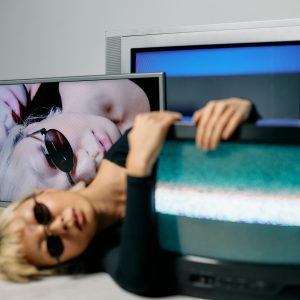 Edgy Fashion Editorial In A Studio Setting Featuring CRT Technology And Chic Sunglasses.