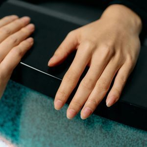 Artistic Close Up Of Hands With Manicured Nails On A Vintage CRT Television, Captured With Selective Focus.