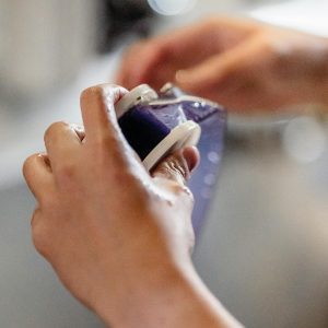 A Close Up Of Hands Holding And Winding A Film Reel, Showcasing Traditional Photography Techniques.