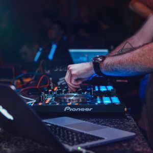 DJ Performing With Mixer In A Vibrant Nightclub Setting. Perfect For Entertainment And Technology Themes.