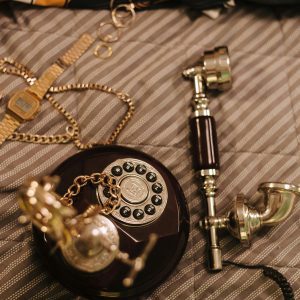 An Elegant Vintage Rotary Phone Accompanied By Stylish Accessories, Conveying Nostalgic Vibes.