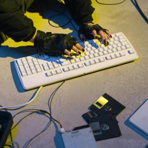 Cyberpunk Themed Image Showing A Hacker Typing On A Keyboard With Retro Technology.