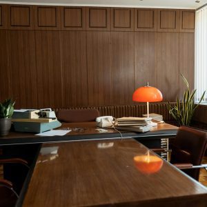 Vintage Office Setup Featuring A Typewriter, Rotary Phone, And Retro Furnishings.