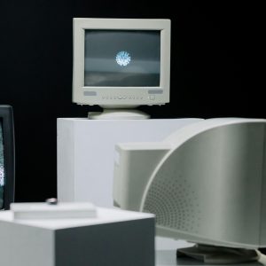 Vintage Monitors Displayed With Static Screens In A Dark Studio Setting.