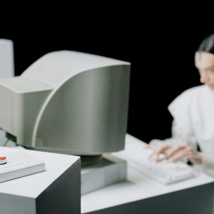 A Scientist Working In A Laboratory With Vintage Computer Equipment And A Warning Button.