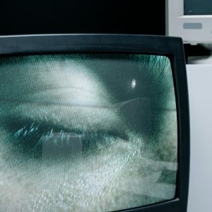A Close Up Of A Closed Eye Displayed On A Vintage Television Screen.
