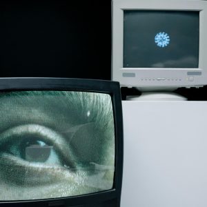 Retro TV And Computer Monitor Showing Eye And Virus Image, Depicting Surveillance And Medical Research Themes.