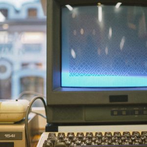 Retro Computing Setup With A Vintage CRT Monitor, Keyboard, And Hardware, Showcasing Nostalgia.