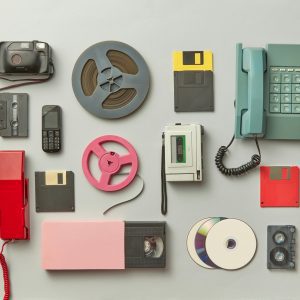 Collection Of Vintage Gadgets Including Telephones, Cassettes, And Floppy Disks.
