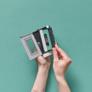 A Pair Of Hands Holding A Vintage Cassette Player Against A Pastel Background. Retro Vibes.