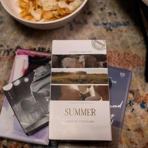 Vintage Movie Night Setup Featuring VHS Tapes And Snacks On A Cozy Carpet.