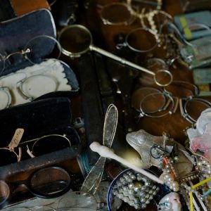 A Close Up View Showcasing A Diverse Collection Of Vintage And Antique Items, Including Eyewear And Jewelry.