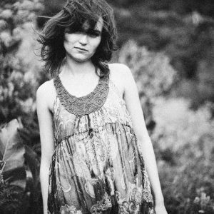 Artistic Grainy Portrait Of A Boho Styled Woman Outdoors, Embracing Nature.
